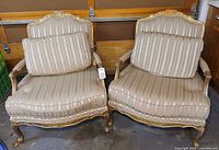 Front view of both chairs showing upholstery and gilt frames