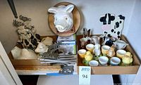 Both trays with pig plaque, cow switch cover, egg cups, doorstop visible