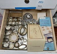 Drawer view of assorted molds, cutters, boxed silicone liners