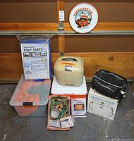 Group shot of all camping items including fridge, tarps, bike pack, tote, Duet-Pac, Tube Tent, bungees