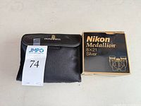 Nikon box and Bushnell case side by side