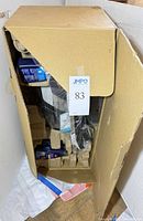 Open shipping box showing CrossWave cleaner components, bottles and inserts