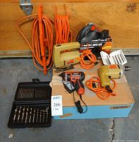 Overall lot showing drill, jigsaw, two cordless screwdrivers, both bit sets, orange cords visible