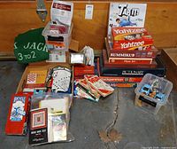 Full lot showing stacked board games, cards, accessories and toys