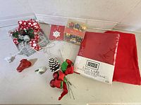 Assorted ornaments, tablecloth package, spray and other small items