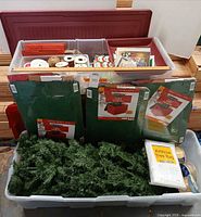 Overall view of two totes with tree sections, ribbon, card packs, storage bag kits