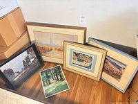 Group shot of all five artworks leaning against wall