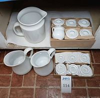 Group shot of three pitchers and boxed lidded jars