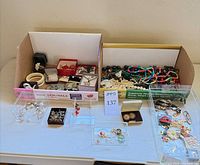 Overall lot showing two trays with jewelry and watches