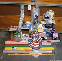 Full lot overview with table cover rolls, plates, cups, flatware