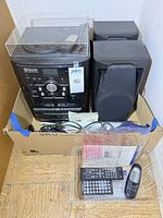 Main unit, two speakers, cords, remotes in box
