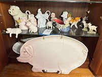 Overview of lot showing pig platter and multiple farm animal creamers, shakers and figurines