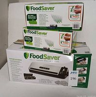 Boxed FoodSaver FM2431 with two smaller boxes on top