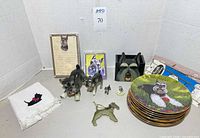 Group shot of towel, figurines, ornament, holder, stationery, stacked plates