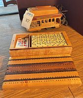 Cable car telephone, wooden game box open showing dominoes and cards, cribbage board lid