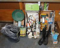 Entire lot of assorted gardening supplies arranged on floor