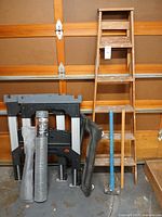 All items grouped: ladder, sawhorse, sledgehammer, dolly, hardware cloth