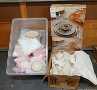 Overall lot with bin of wrapped Lenox porcelain, cardboard box with porcelain pieces, and two boxed sets of gold charger plates
