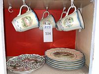 Lenox Provencal Garden mugs hanging, stack of Lenox plates, Chinese Famille Rose plate visible