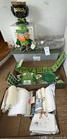 Group shot showing ceramic cauldron, leprechaun plush, platters, sign, towels, bin