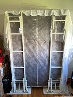 Front view of vertical Murphy bed frame with plastic cover