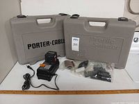 Both Porter-Cable hard cases, charger and loose accessories
