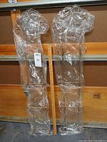 Two metal plate racks still in plastic wrap shown beside yardstick