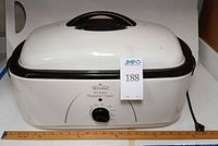 Front view of Rival 20 qt roaster oven with dial and ruler for scale