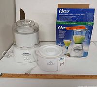 Cuisinart ice cream maker, Rival Crock-Pot, Oster blender in box