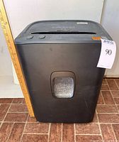 Front view of black Royal shredder showing pull-out bin window and scale