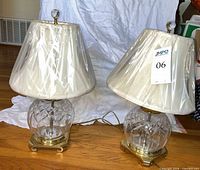 Both matching crystal and brass table lamps with shades