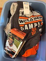 Tops and bobblehead packed in blue tote