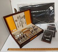 Overall view showing flatware case, utensils, and three packages of place-setting rolls
