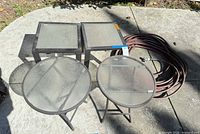 Top view showing two square tables, two round tables and coiled red hose