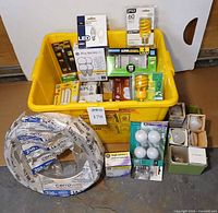 Overview of yellow tote filled with various bulb packages and coil of CerroWire