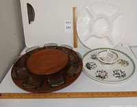 Overview of three serving pieces: lazy Susan with glass dishes, white divided platter, Portmeirion chip-and-dip set