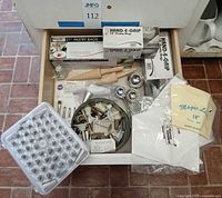 Drawer view showing boxes of pastry bags, plastic tip case, metal tips, couplers, brushes, rolling pin