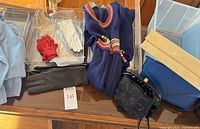 Overview of navy dress, gloves, handbags