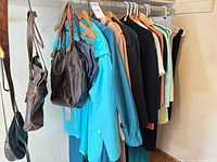 Rack of assorted women’s clothing and handbags