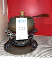 Complete fondue set assembled showing pot, lid, handle, stand, burner and drip tray