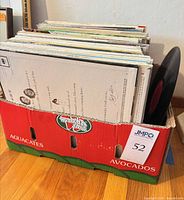 Front view of cardboard box containing stack of vinyl LPs