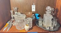 Shelf view showing all glassware, decanter set, candleholders and decorative pieces