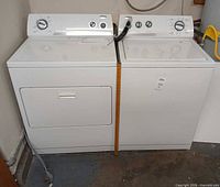Front view of washer and dryer set side by side