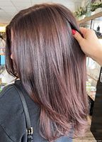 Woman with freshly styled hair demonstrating salon service quality
