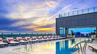 Rooftop heated pool with lounge chairs at Hotel X Toronto