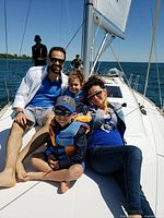 Family aboard sailboat illustrating shared sailing experience