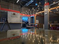 Interior of Bullseye Axe Throwing venue with merch area and wall of champions