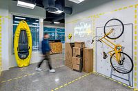 Interior view of XYZ Storage facility showing kayak, bicycle and packed boxes illustrating storage unit capacity