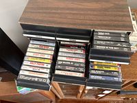 Open drawers showing cassette tapes with visible artist spines