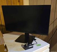 Front view of monitor on stand with power adapter visible